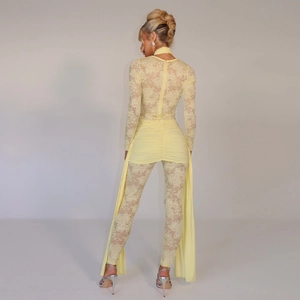 Detail of yellow lace bodysuit featuring back cutout and elegant sheer trailing fabric