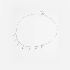 Detail of silver lightning bolt necklace featuring seven shimmering zircon pendants on fine chain