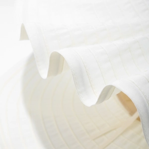 Detail of white sun hat brim featuring precision stitching and premium fabric texture