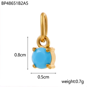 Macro detail of sky blue round cubic zirconia pendant with gold four-prong setting