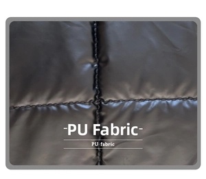Detailed view of black quilted PU leather material with classic puffer square texture