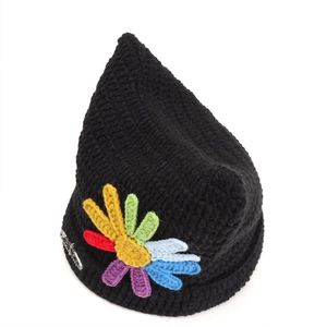 Detailed knit texture of a black cat ear beanie with colorful crochet daisy and silver pin