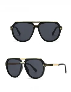Detail view of retro oversized aviator sunglasses with black frame and gold metal accents