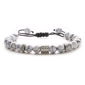 Detail of white howlite beads with silver textured spacers on adjustable woven cord