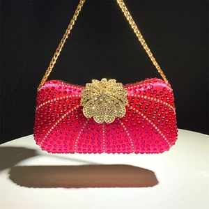 Detail of rose red rhinestone evening clutch bag with gold flower clasp and chain