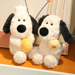 Plush dog dolls with chef hat and fried egg props on a warm wooden tabletop