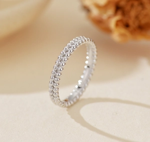 Macro shot of silver S925 minimalist double-row beaded ring with polished metallic finish