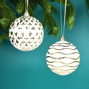 Christmas tree ornaments featuring white balls with golden wave and diamond embossed patterns