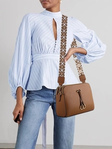 Brown leather crossbody bag with patterned canvas strap and decorative drawstring detail