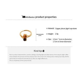 Detail view of gold ring with tiger eye stones and zircons showing size and weight specs