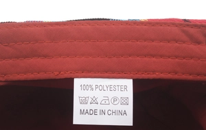 Detail shot of the 100% polyester label and neat red inner stitching of the plaid cap