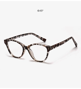 Detailed 45-degree angle view of vintage tortoise shell cat-eye glasses with metal rivets