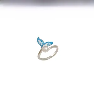 Detail of silver fish tail ring with blue enamel and natural freshwater pearl