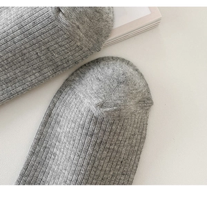 Close-up of the grey knitted sock toe featuring soft cotton texture and fine stitch detail