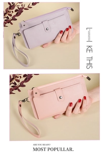Detailed view of long leather wallets in light purple and nude pink with wrist straps