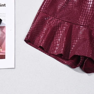 Detail view of burgundy crocodile texture PU leather skirt with ruffled hemline
