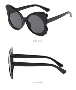 Macro view of oversized butterfly wing frame sunglasses with glossy black finish