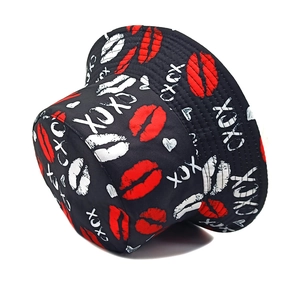 Detail view of black bucket hat with red lips pattern and white XOXO print design