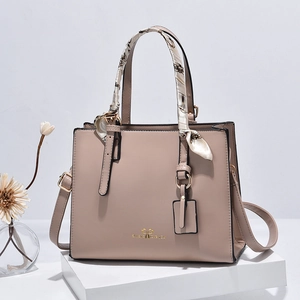 Chic khaki PU leather chain handbag with decorative scarf and shoulder strap on white stand