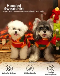 Close-up of dogs wearing colorful striped Christmas hoodies in a festive cozy setting