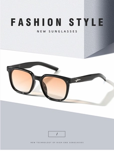 Detail of square black sunglasses with orange gradient lenses and star-shaped metal hinge