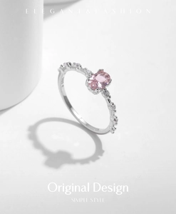 Macro shot of S925 sterling silver ring featuring an oval pink gemstone and side diamonds