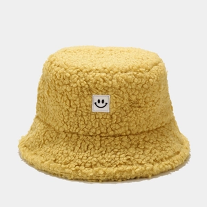 Bright yellow teddy fleece bucket hat for women with a minimalist smiley face patch