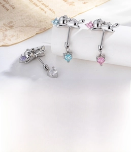 Detail of titanium steel cat ear cartilage studs with heart-shaped colorful zircons