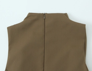 Detail showing the invisible zipper closure and high neck collar of the khaki sleeveless top