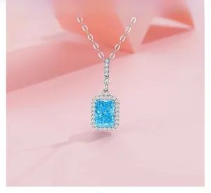Macro detail of S925 silver necklace with rectangular ice blue crystal pendant set in diamonds