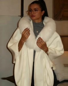Close-up of elegant white mid-length faux fur coat with plush collar and textured wool fabric