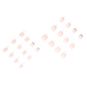 Classic nude French press-on nails with white tips and rhinestone accents in almond shape
