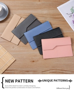 Flat lay of colorful PU leather envelope wallets on a wooden background with accessories