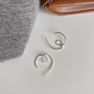 Minimalist S925 sterling silver ripple hoop earrings on white background with knit fabric