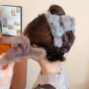 Plush faux fur hair claw clip with knit bow detail for women's elegant thick hair styling