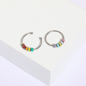 Silver enamel bead ring set with multi-color accents on white geometric stand