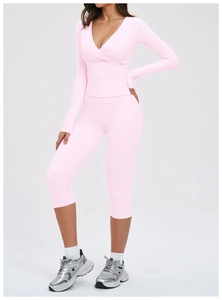 Detail of pink three-piece yoga set with cross-wrap long sleeve top and high waist leggings