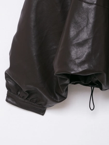 Dettaglio giacca in ecopelle marrone con polsini elastici e orlo regolabile con coulisse