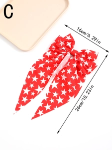Detail showing red American flag bow hair clip with white stars and 16x26cm dimensions