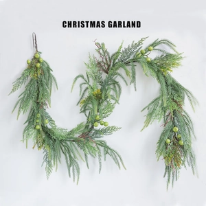 Close-up detail of green Christmas garland with pine needles and berries for decor