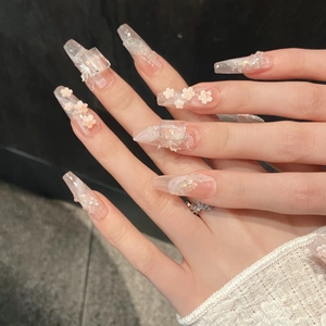 Handcrafted pink floral press-on nails in long coffin shape with 3D cherry blossoms