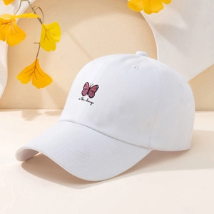 Detailed embroidery of pink butterfly and 'the change' text on white cotton baseball cap
