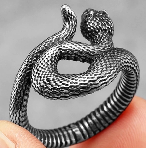 Macro detail of silver snake ring showing intricate scale textures and punk style