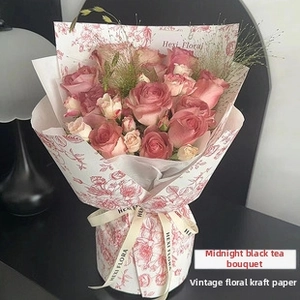 Midnight Black Tea rose bouquet wrapped in vintage floral kraft paper with LED string lights
