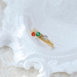 Detailed view of three 18k gold plated titanium steel rings with colorful zircon stones