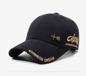 Close-up of black baseball cap with gold CHINESE DREAM embroidery and metal badge