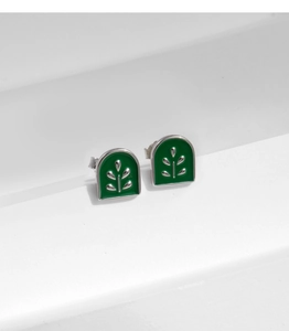 Close-up of S925 silver arch earrings with green enamel and leaf pattern inlay