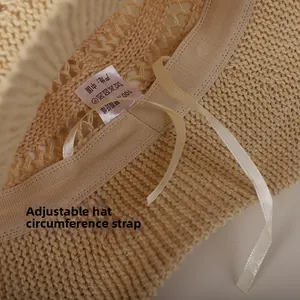 Detail view of the beige sun hat interior with adjustable drawstring and knit texture