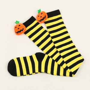 Detail of Halloween over-knee socks with black and yellow stripes and 3D pumpkin decor