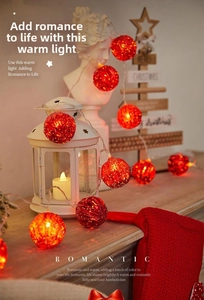 Close-up of red hollow metal ball LED fairy lights with warm glowing star pattern